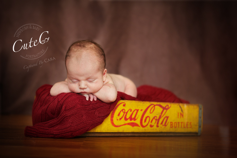 baby in coca cola crate