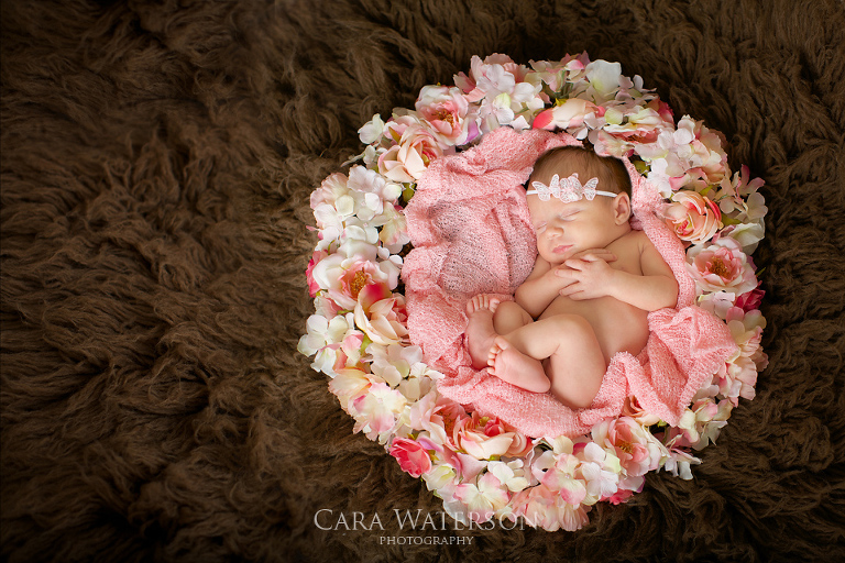 newborn girl in flowers