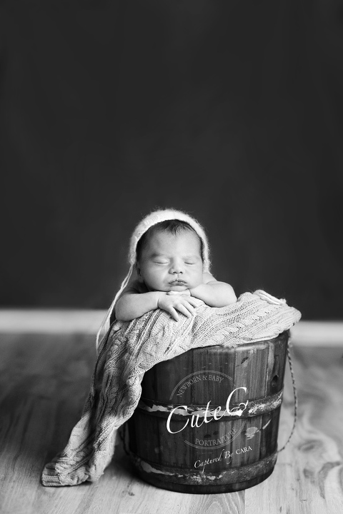 b&w newborn in bucket