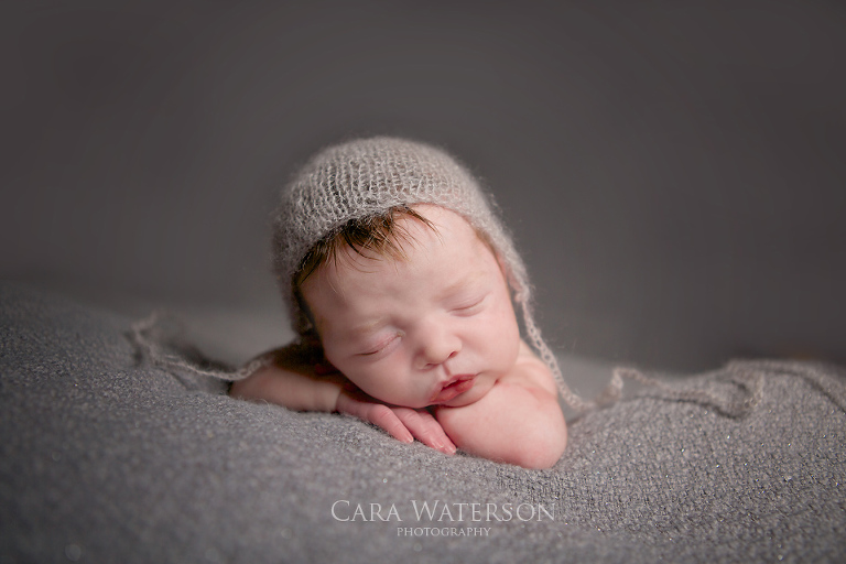 baby in grey bonnet