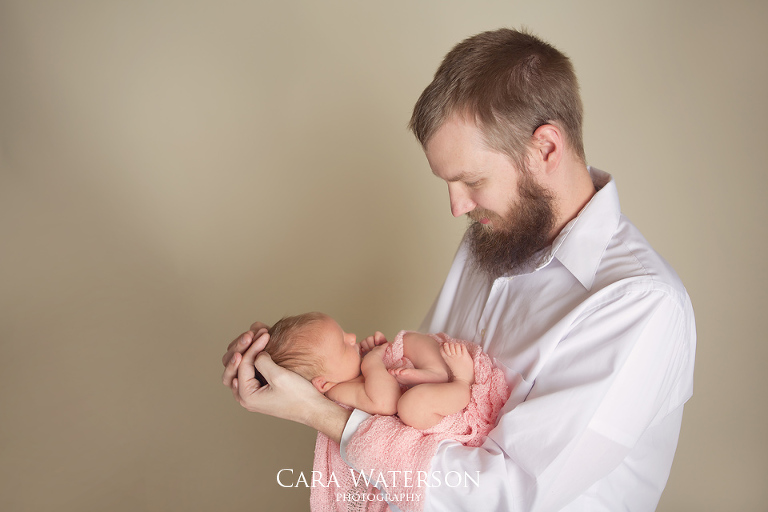 newborn girl in daddies arms