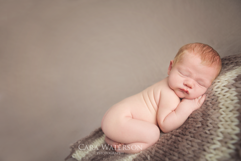 baby on tan blanket