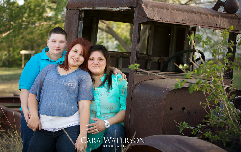 family on rusted truck