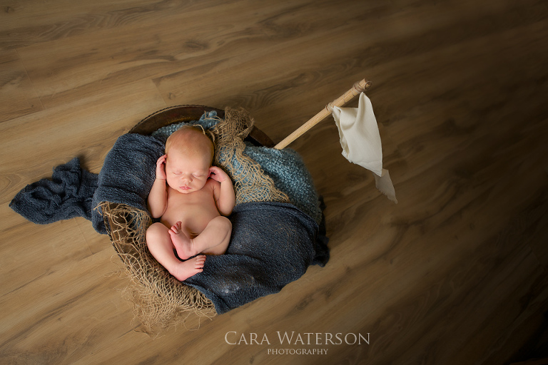 newborn in a tub boat