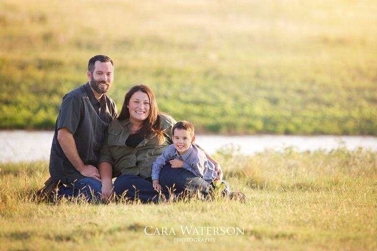 family sitting in a field