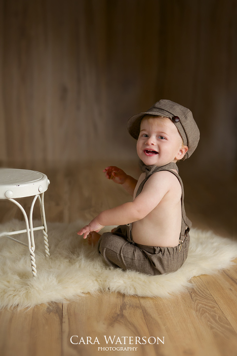 boy sitting in cap